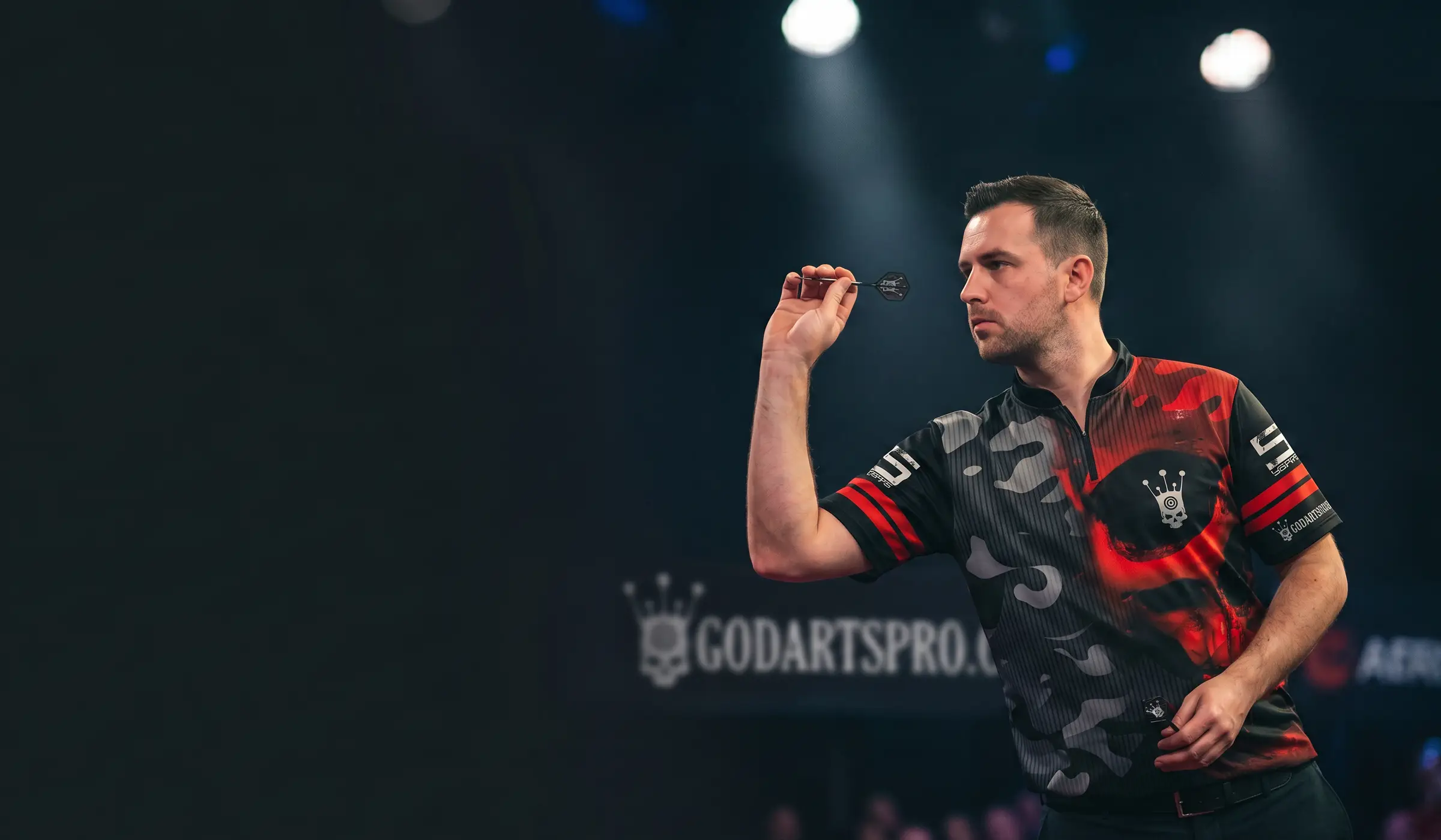 Focused darts player throwing a dart on a tournament stage